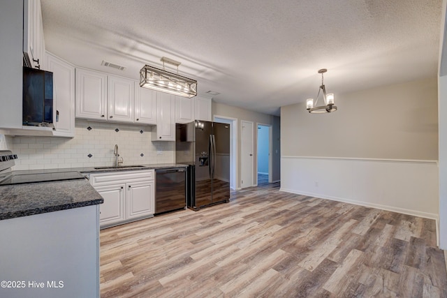 137 El Ogden Dr, Wilmington, NC 28411 - kitchen with black appliances, visible vents, and white cabinetry