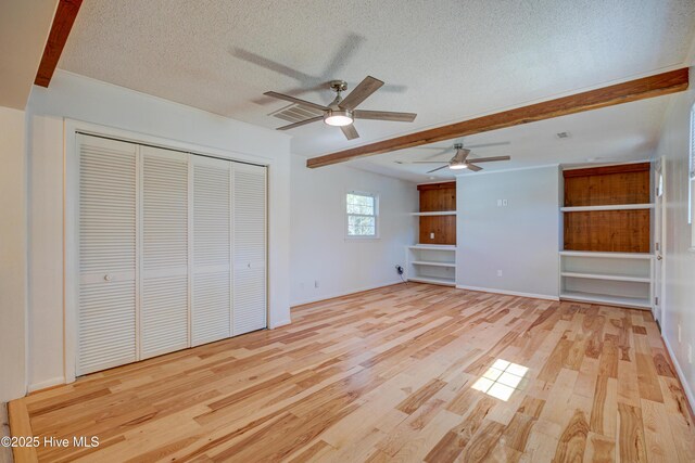 137 El Ogden Dr, Wilmington, NC 28411 - interior space featuring light wood finished floors, visible vents, baseboards, beamed ceiling, and a textured ceiling