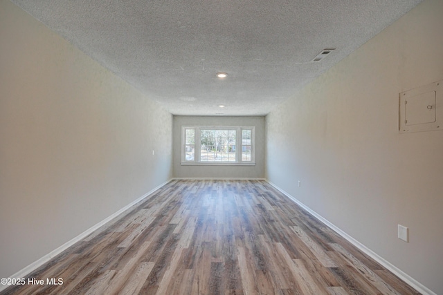 137 El Ogden Dr, Wilmington, NC 28411 - spare room with visible vents, a textured ceiling, baseboards, and wood finished floors