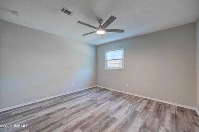 137 El Ogden Dr, Wilmington, NC 28411 - empty room with a textured ceiling, ceiling fan, wood finished floors, visible vents, and baseboards