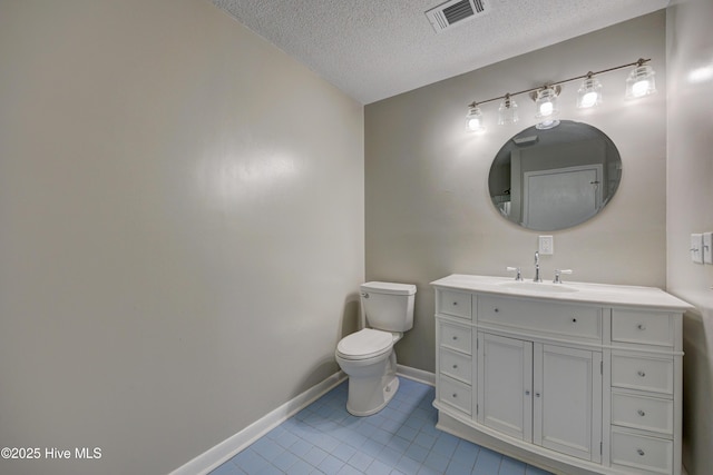 137 El Ogden Dr, Wilmington, NC 28411 - bathroom featuring baseboards, visible vents, toilet, tile patterned floors, and a textured ceiling