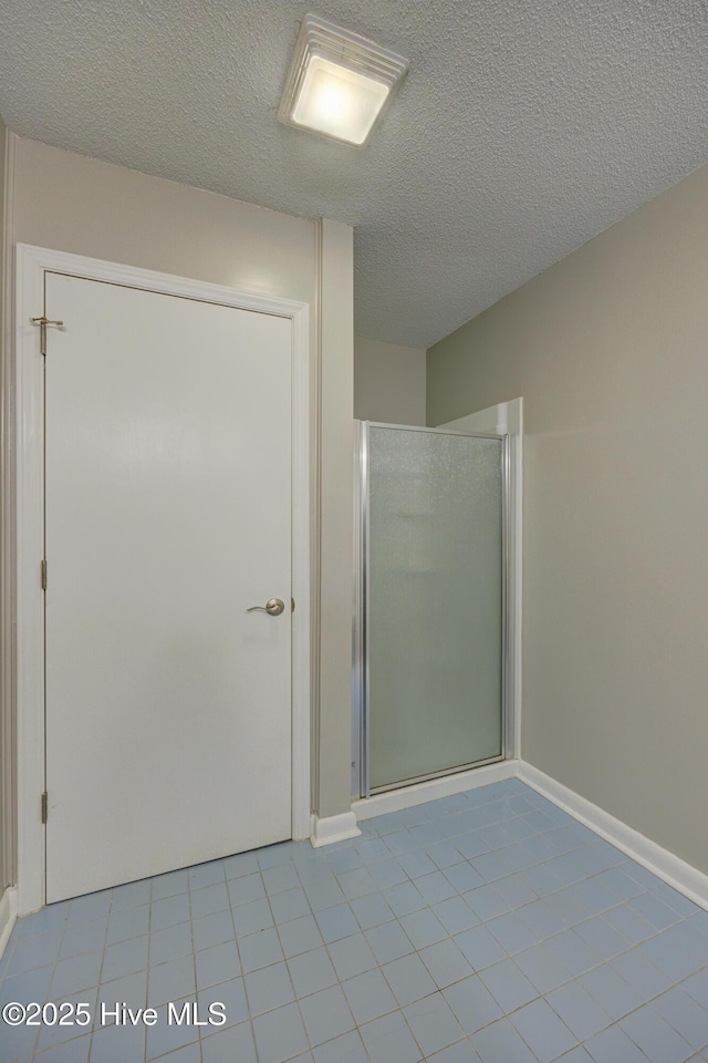 137 El Ogden Dr, Wilmington, NC 28411 - bathroom with a textured ceiling, a stall shower, and tile patterned flooring