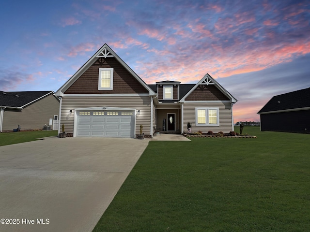 view of front facade with a lawn and concrete driveway