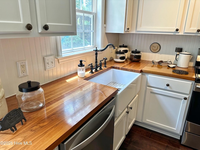 kitchen with dishwashing machine, butcher block countertops, dark wood-style floors, and a sink