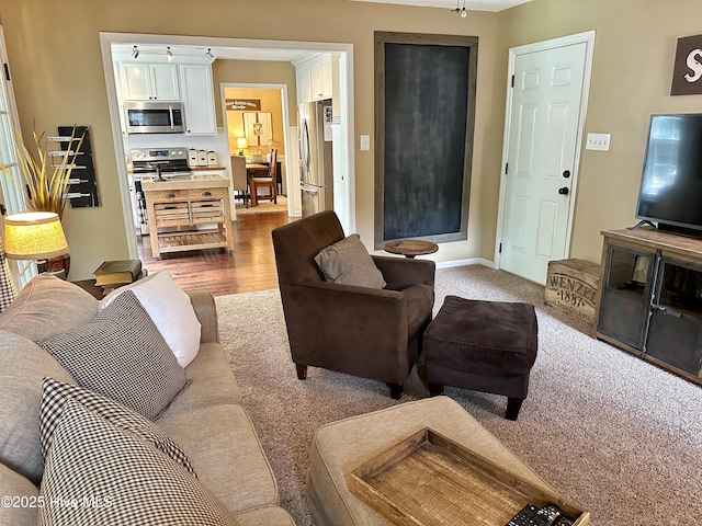 living room featuring dark wood-style floors and baseboards