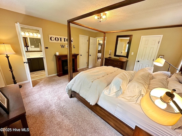 bedroom featuring light carpet, baseboards, connected bathroom, an inviting chandelier, and a textured ceiling