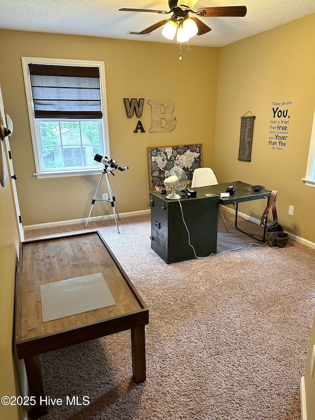 carpeted office featuring a ceiling fan, a textured ceiling, and baseboards