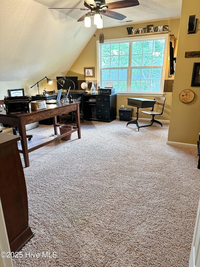 carpeted office featuring lofted ceiling, baseboards, a ceiling fan, and a textured ceiling