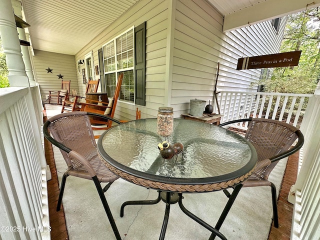 balcony featuring covered porch and outdoor dining area