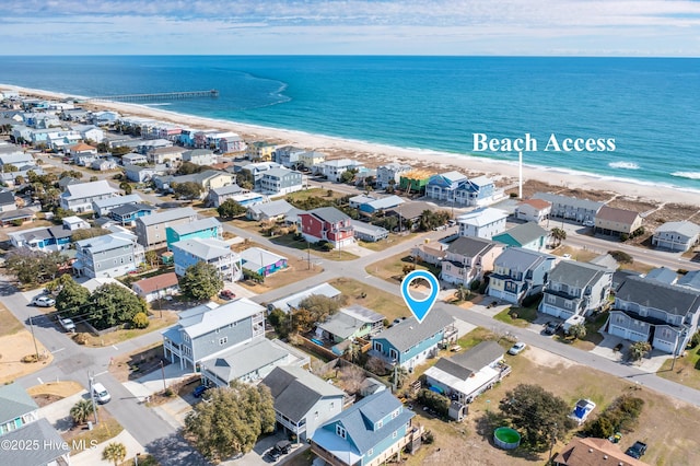 aerial view with a residential view, a beach view, and a water view