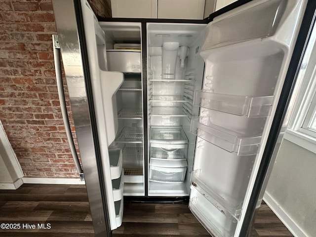 interior details with dark wood finished floors, baseboards, and fridge