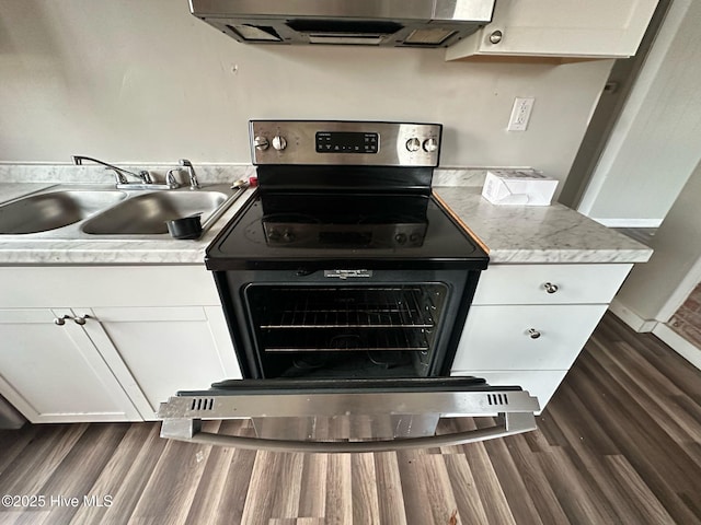 kitchen with a sink, white cabinets, light countertops, ventilation hood, and stainless steel electric range