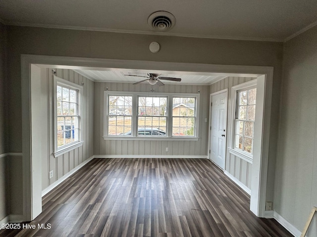 unfurnished sunroom with visible vents and a ceiling fan