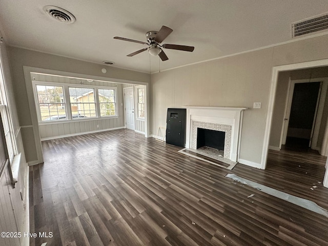 unfurnished living room featuring a fireplace with flush hearth, crown molding, visible vents, and dark wood-style flooring