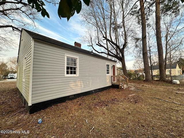 view of side of property with a chimney