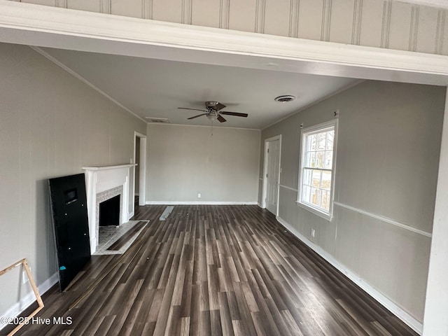 unfurnished living room featuring dark wood-type flooring, a fireplace, visible vents, and crown molding