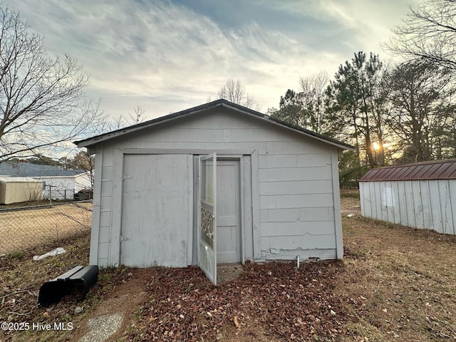 view of shed featuring fence