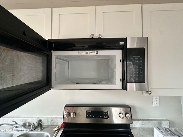 details with appliances with stainless steel finishes and a sink