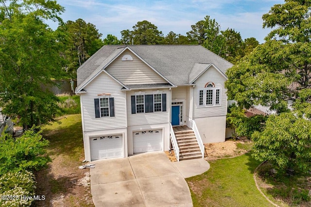 917 Hearthside Ct, New Bern, NC 28560 - view of front facade featuring an attached garage, driveway, a front lawn, a shingled roof, and stairs