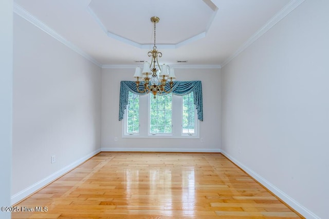 917 Hearthside Ct, New Bern, NC 28560 - spare room featuring a chandelier, wood finished floors, a tray ceiling, baseboards, and ornamental molding