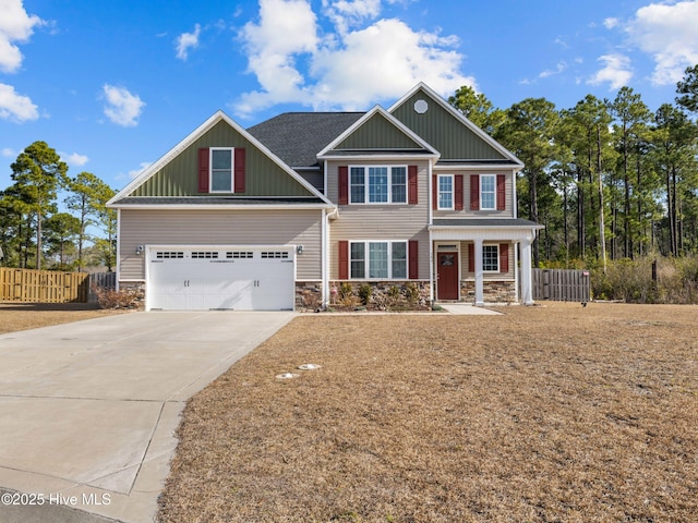 craftsman house with driveway, stone siding, a garage, and fence