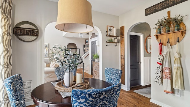 dining space with wood finished floors and baseboards