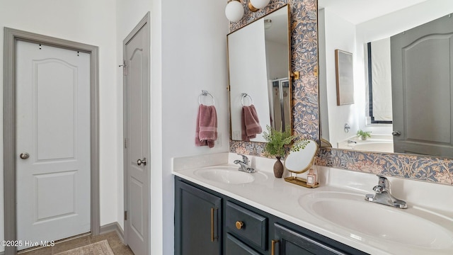 full bath with a sink and double vanity