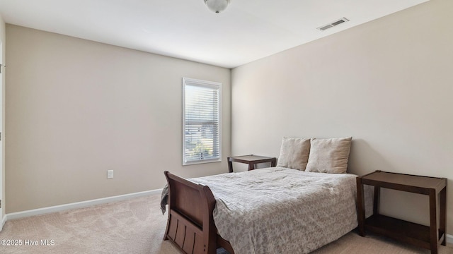 bedroom featuring visible vents, light carpet, and baseboards