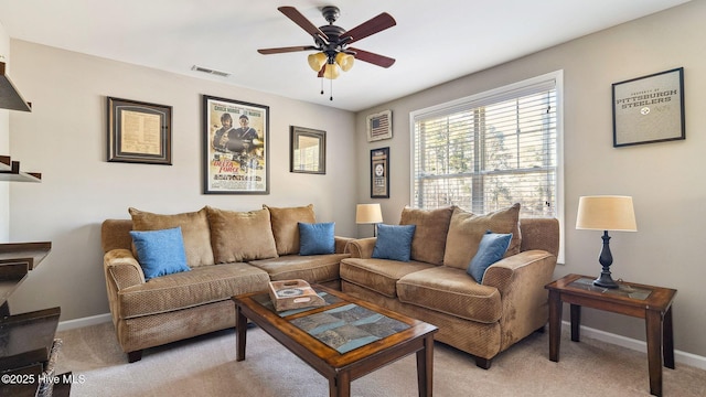 living area featuring a ceiling fan, light colored carpet, visible vents, and baseboards