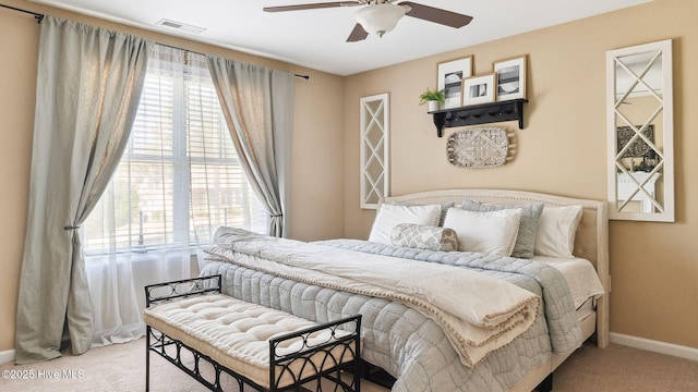 carpeted bedroom featuring visible vents, ceiling fan, and baseboards