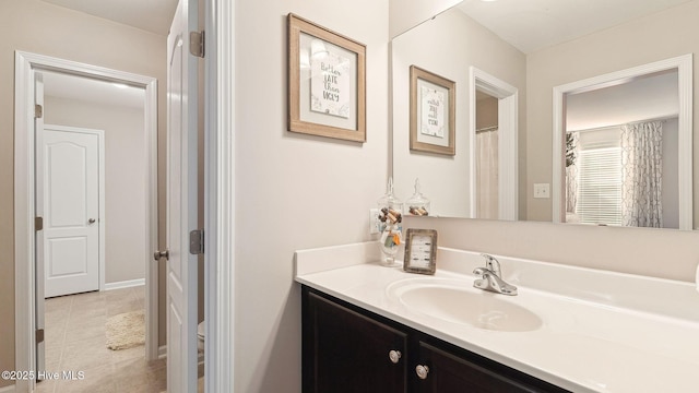 bathroom with vanity, toilet, and tile patterned floors