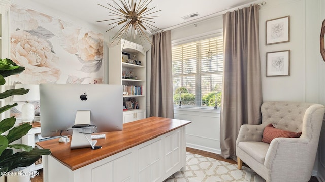 office area featuring light wood-style flooring and visible vents