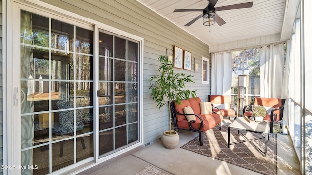 sunroom / solarium featuring ceiling fan