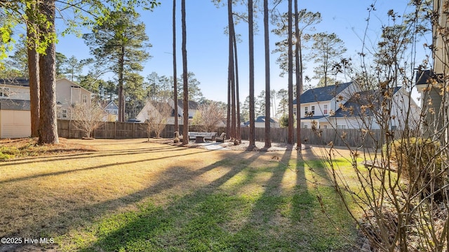 view of yard featuring a fenced backyard and a residential view