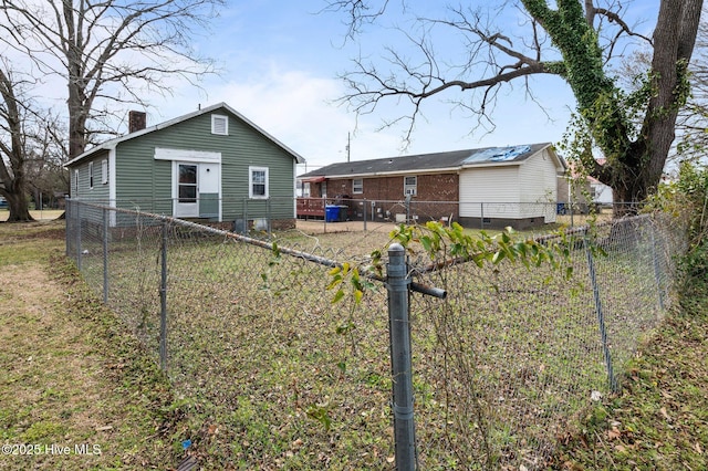 back of property featuring crawl space, a chimney, and a fenced backyard