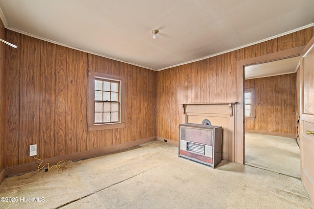 spare room with a healthy amount of sunlight, wood walls, and ornamental molding