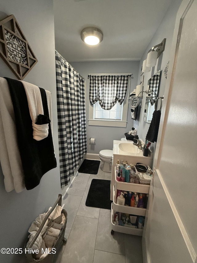 full bathroom featuring tile patterned flooring, curtained shower, vanity, and toilet