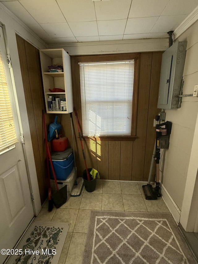 doorway to outside featuring tile patterned flooring and electric panel