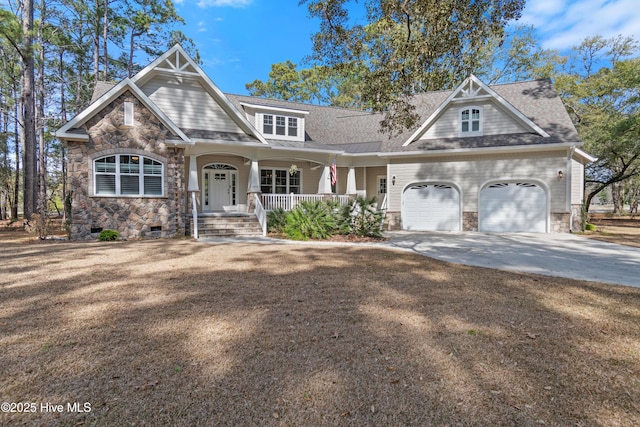 craftsman house with a garage, covered porch, a shingled roof, and concrete driveway