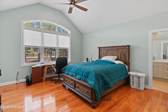 bedroom with lofted ceiling, ceiling fan, baseboards, light wood-type flooring, and ensuite bath