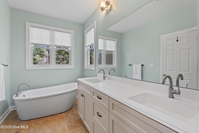 full bath with double vanity, a soaking tub, a sink, and tile patterned floors