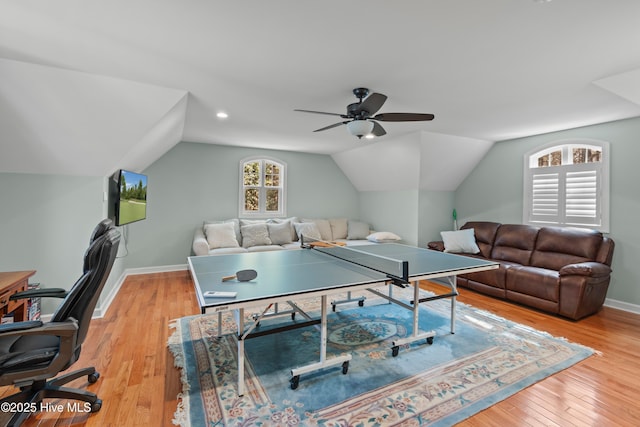 recreation room featuring lofted ceiling, ceiling fan, light wood finished floors, and baseboards