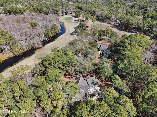 aerial view with a water view and a wooded view