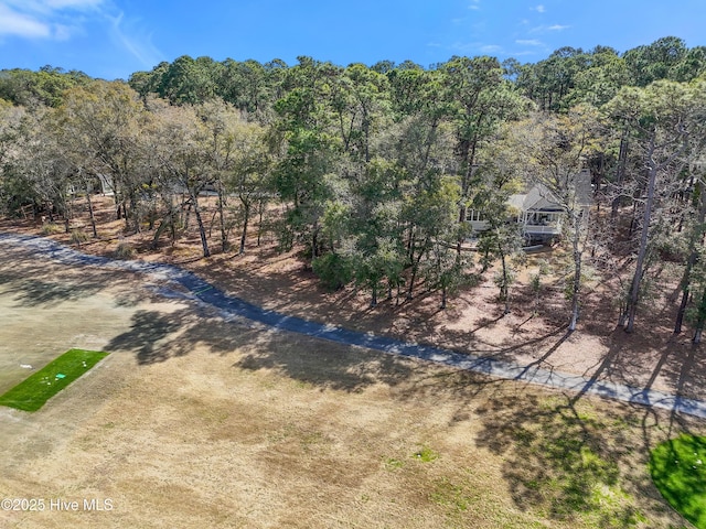 drone / aerial view with a wooded view