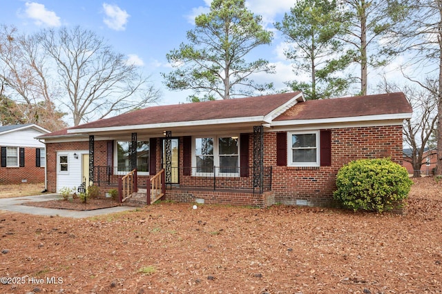 ranch-style house featuring crawl space, covered porch, and brick siding