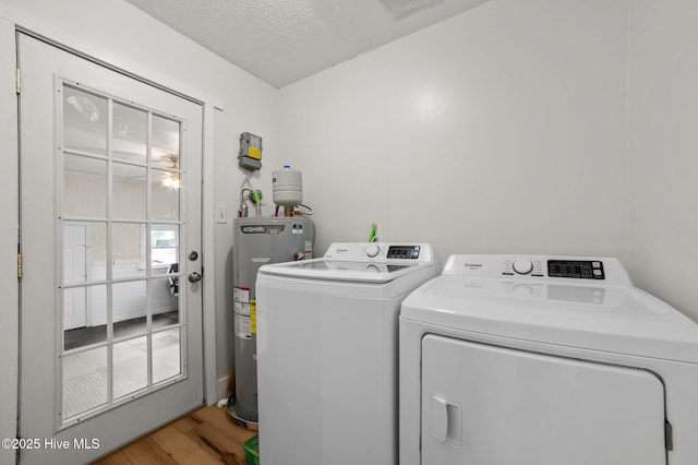 laundry room with washing machine and dryer, laundry area, water heater, and light wood finished floors