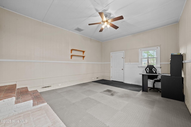 interior space featuring ceiling fan and visible vents