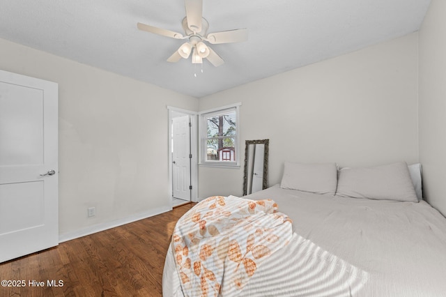 bedroom featuring ceiling fan, wood finished floors, and baseboards