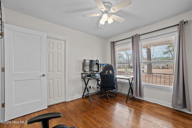 office featuring ceiling fan, baseboards, and wood finished floors