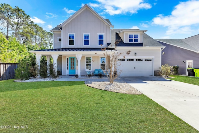 modern inspired farmhouse with a standing seam roof, fence, covered porch, board and batten siding, and a front yard